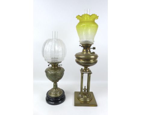 Two Victorian brass paraffin lamps, one with brass reservoir and unusual base with four column on a square foot, yellow to cl