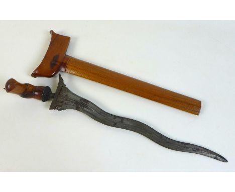 A South East Asian kris dagger, with decorative carved wooden handle and scabbard, blade 37cm, 46cm long overall. 