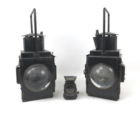 A pair of black British Rail lamps, both in black, with magnified lenses, each 20 by 24 by 45cm high, together with a Miller 