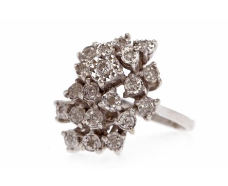 EIGHTEEN CARAT WHITE GOLD DIAMOND CLUSTER RINGthe bezel of spray form with illusion set round brilliant cut diamonds, the dia