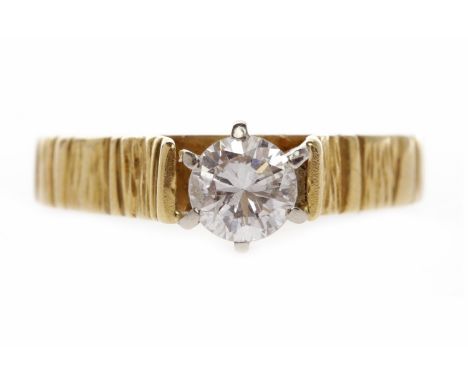 DIAMOND SOLITAIRE RINGset with a round brilliant cut diamond of approximately 0.51 carats, on an eighteen carat gold bark eff