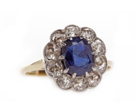 EIGHTEEN CARAT GOLD SAPPHIRE AND DIAMOND CLUSTER RINGset with a central oval sapphire 7.6x5.8x3.4mm, surrounded by round diam