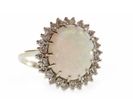 EIGHTEEN CARAT WHITE GOLD OPAL AND DIAMOND CLUSTER RINGset with a central oval cabochon cut opal 14.5mm long surrounded by si