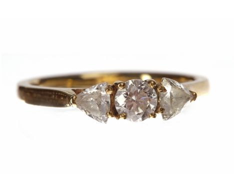 NINE CARAT GOLD DIAMOND THREE STONE RINGset with a central round brilliant cut diamond of approximately 0.28 carats flanked b