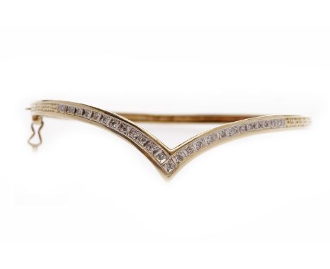 NINE CARAT GOLD DIAMOND BANGLEwith illusion set round brilliant cut diamonds totalling approximately 0.25 carats, 5.5cm inner