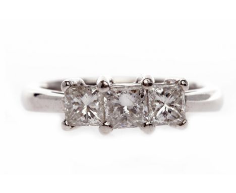 EIGHTEEN CARAT GOLD DIAMOND THREE STONE RINGset with a central princess cut diamond of approximately 0.25 carats, flanked by 