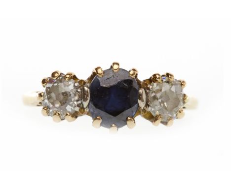 EIGHTEEN CARAT GOLD SAPPHIRE AND DIAMOND THREE STONE RINGset with a central oval sapphire 6mm long flanked by two old round b