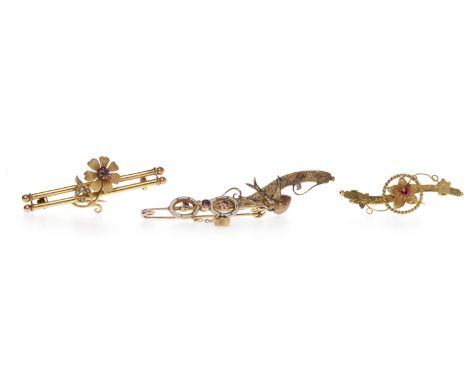 THREE VICTORIAN BAR BROOCHEScomprising a fifteen carat gold garnet and pearl set floral motif bar brooch, 44mm long, 3.1g; a 