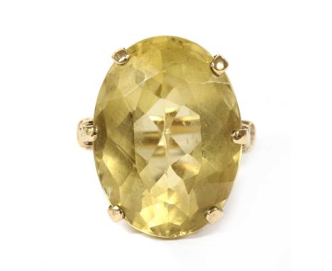 A 9ct gold single stone citrine ring, an oval mixed cut citrine, claw set to pierced lozenge gallery, with trifurcated should