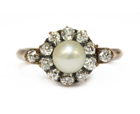 A gold cultured pearl and diamond cluster ring, a cultured pearl, peg set to the centre, to a surround of old European cut di