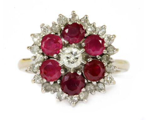 A white gold diamond and ruby target cluster ring, a brilliant cut diamond to the centre, with a border of circular mixed cut