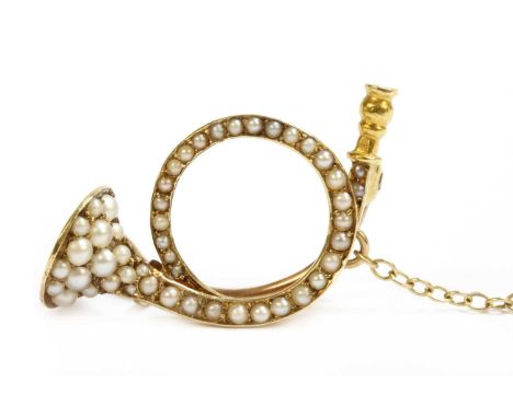 A gold split pearl brooch, in the form of a hunting horn, with pin and 'C' catch. Tested as approximately 15ct gold, with 9ct
