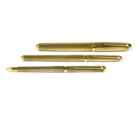 A cased sterling silver pen set by Asprey, with silver gilt roller ball, ballpoint and fountain pens, all with engine turned 