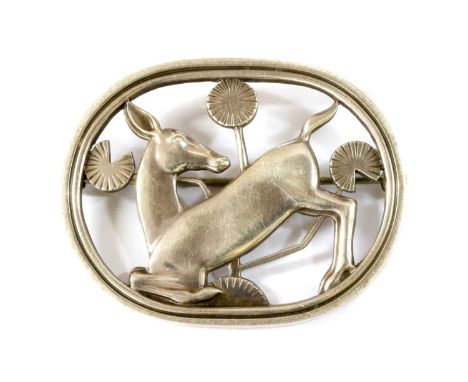 A sterling silver kneeling deer brooch, by Georg Jensen, no 256, designed by Arno Malinowski, the kneeling deer amongst styli