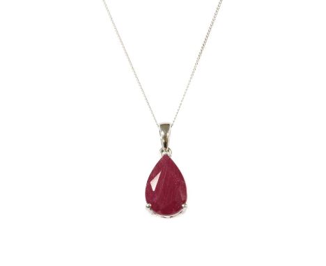 A white gold single stone ruby pendant, a pear mixed cut ruby, fracture filled, claw set to a pierced scroll galley, with art