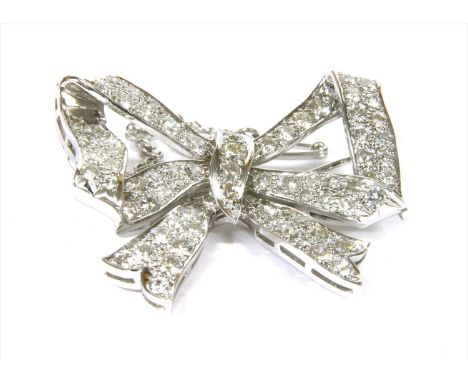 A diamond set bow brooch, with an open ribbon bow, grain set throughout with brilliant cut diamonds, to pin, roller catch and