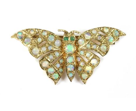 A 9ct gold opal set butterfly brooch, with circular mixed cut emerald eyes, to wings and abdomen grain set throughout with ca