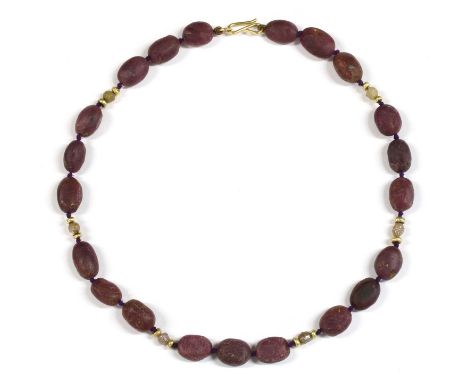 A gold ruby and diamond necklace, sets of three oval ruby beads with rough diamond crystal and gold rondelle spacer beads bet
