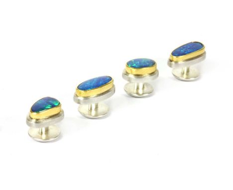 A set of sterling silver and gold boulder opal dress studs by Josef Koppmann, four studs, each with a freeform boulder opal r