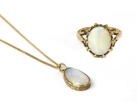 A gold single stone opal pendant, tested as approximately 9ct gold, 13.7 x 8.2mm (excluding jump ring), suspended on a 9ct go