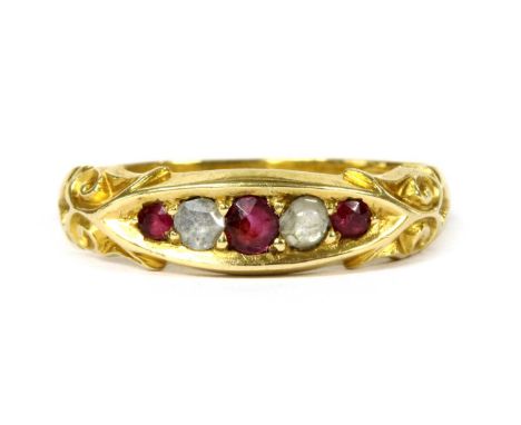 A 15ct gold ruby and diamond ring, a row of graduated alternating circular mixed cut rubies and rose cut diamonds, grain set,