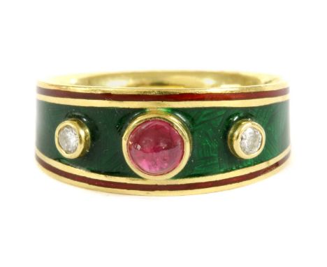 An 18ct gold enamel ruby and diamond ring,a round cabochon ruby with a brilliant cut diamond at each side, all rub set to pla