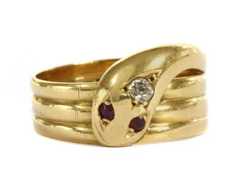 An 18ct gold diamond and ruby set snake or serpent ring, with a three row coiled snake with an old European cut diamond grain