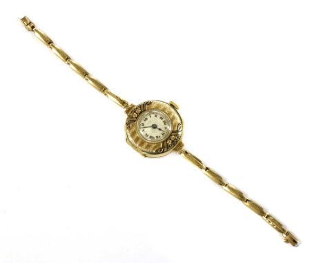 A gold Juco mechanical bracelet watch, 25mm diameter with a silvered dial, Roman numerals and blued hands, to wide bezel with