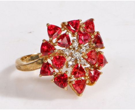 A 9 carat gold, diamond and tanzanian ruby cluster ring, the head in the form of a flower set with claw mounted tanzanian rub