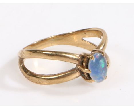 A 9 carat gold and opal ring, the head set with a claw mounted oval opal with bands forming the shoulders, ring size P weight