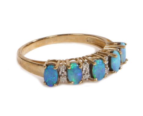 A 9 carat gold, opal and diamond ring, the head set with five claw mounted oval opals with intersecting diamonds, ring size P