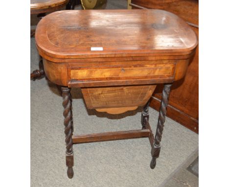 A Victorian walnut and box wood strung games/work table, having fold over swivel top inlaid with draughtsboard, cribbage, and