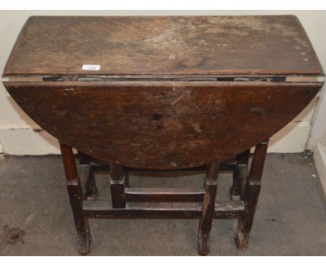 An 18th Century oak gate leg table, raised on turned supports terminating in Braganza type feet, rounded drop leaves, 73cm wi