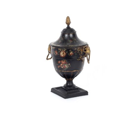 A Regency Toleware chestnut urn, having gilt decoration and rams head mask ring handles, the lid surmounted by foliate finial
