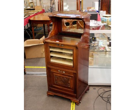 An Edwardian mahogany music cabinet, the raised mirror back surmounted by a three quarter pierced&nbsp; brass gallery, shelve