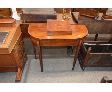 A George III mahogany and rosewood cross banded D shaped fold over card table, raised on square tapering supports and pad fee