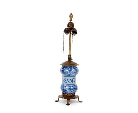 A continental tin glazed Albarello, converted to a table lamp, with gilt metal mounts raised on a pierced base with claw feet