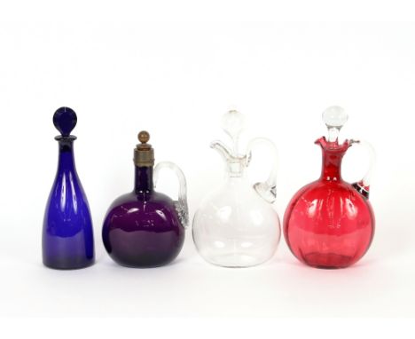 Three various Victorian glass claret jugs and a blue glass decanter