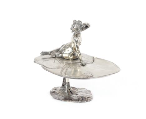 An Art Nouveau WMF style comport,&nbsp;in the form of a semi naked maiden reclining on a lily pad with frog nearby, 26cm long