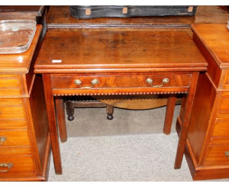 A Georgian mahogany card table, the fold-over top raised on square chamfered supports, 76cm wide&nbsp;