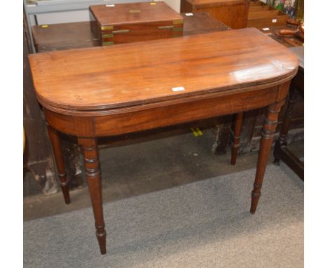 A Georgian mahogany D shaped card table, the fold over top raised on turned tapering supports, 99cm&nbsp;