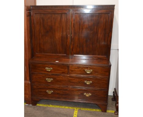 A 19th Century mahogany&nbsp;cabinet on chest,&nbsp;the upper shelves enclosed by a pair of moulded panel doors united by bra