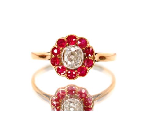 An 18ct gold and platinum ruby and diamond set cluster ring