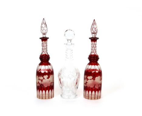 A pair of 19th Century ruby flash decanters, having vine etched decoration and spike shaped stoppers, 37cm high; and a cut gl