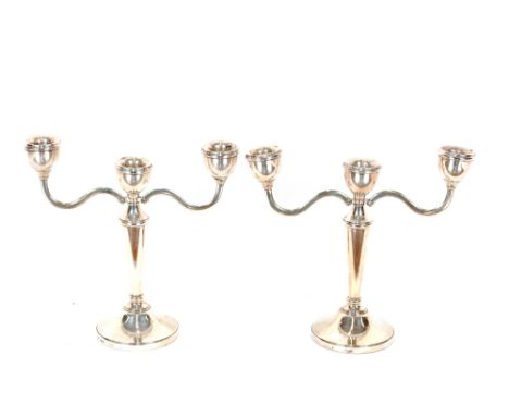 A pair of modern silver three light candelabra, weighted bases, 19cm high