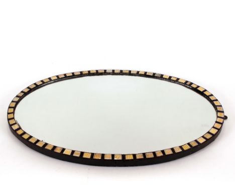 An ebonised blue glass and enamel decorated oval wall mirror, bearing label verso, Charles Carline Carver &amp; Gilder, 79cm 