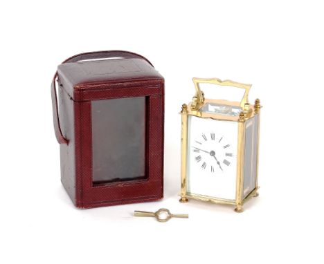 A brass cased carriage timepiece, white enamel Roman numeral dial, angular swing handle, 13.5cm high with handle extended, co