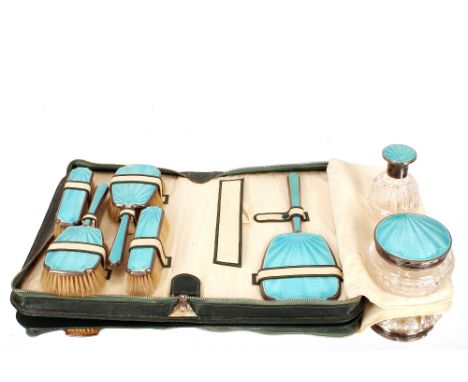 A silver and blue enamel Art Deco part dressing table set, the brushes and mirror contained in a case, (some chipping to the 