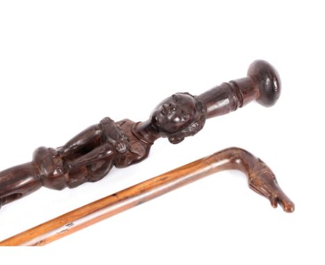 A carved antique walking stick, with horses head handle; and an African carved ebony figural walking stick (2)