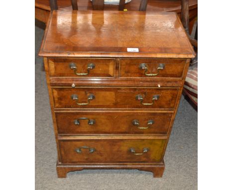 A mahogany and cross banded chest, of two short and three long graduated drawers fitted brushing slide and raised on bracket 